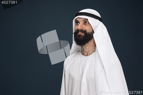 Image of Arabian saudi businessman on dark blue studio background