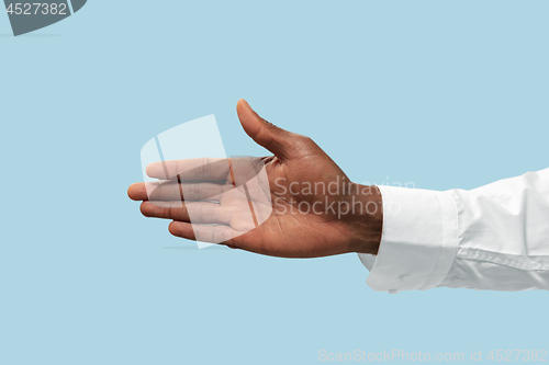 Image of Male hand demonstrating a gesture of inviting isolated on blue background