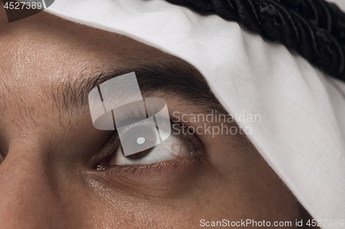 Image of Arabian saudi man on dark blue studio background