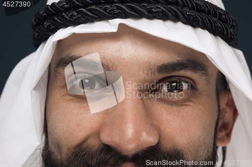 Image of Arabian saudi man on dark blue studio background