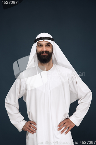 Image of Arabian saudi businessman on dark blue studio background