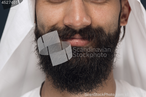 Image of Arabian saudi man on dark blue studio background