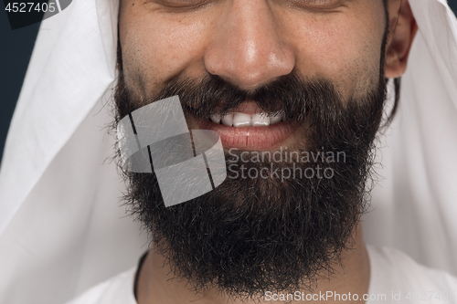 Image of Arabian saudi man on dark blue studio background