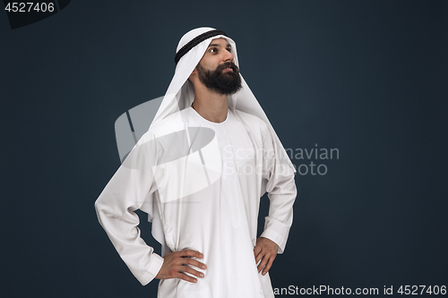 Image of Arabian saudi businessman on dark blue studio background