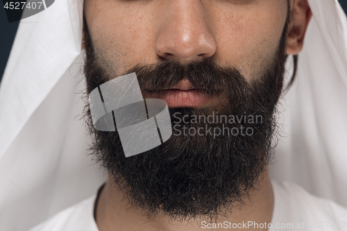 Image of Arabian saudi man on dark blue studio background