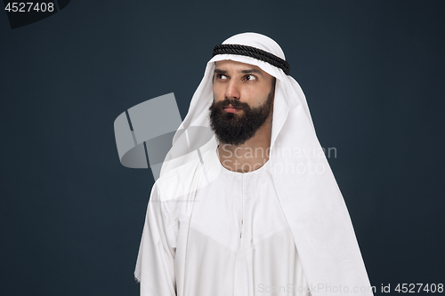 Image of Arabian saudi businessman on dark blue studio background