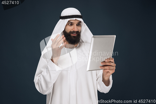 Image of Arabian saudi businessman on dark blue studio background