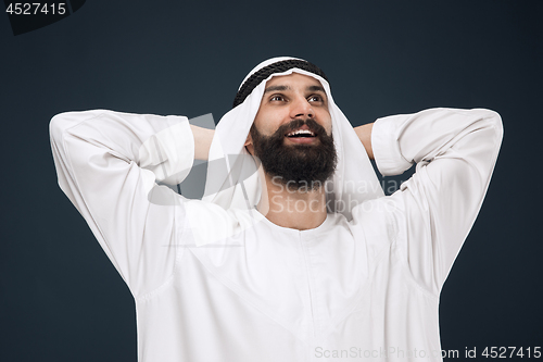 Image of Arabian saudi businessman on dark blue studio background