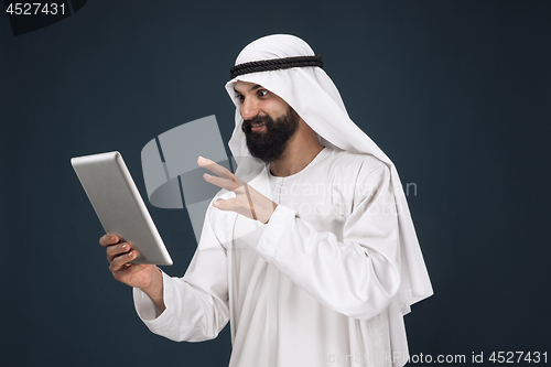 Image of Arabian saudi businessman on dark blue studio background