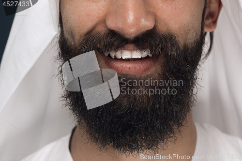 Image of Arabian saudi man on dark blue studio background