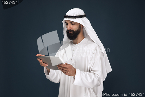 Image of Arabian saudi businessman on dark blue studio background