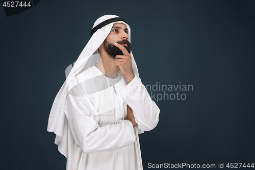 Image of Arabian saudi businessman on dark blue studio background