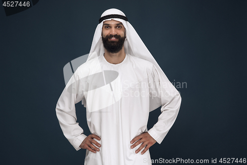 Image of Arabian saudi businessman on dark blue studio background