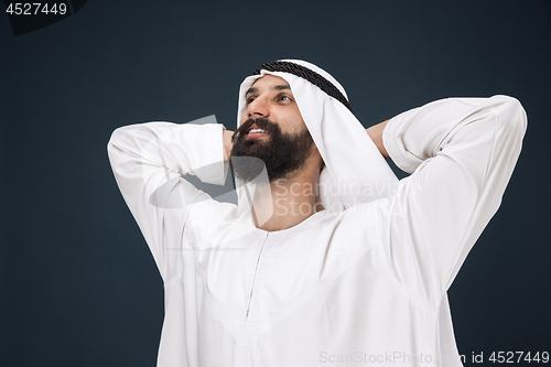 Image of Arabian saudi businessman on dark blue studio background