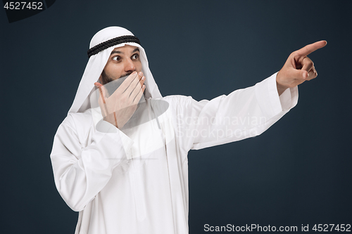 Image of Arabian saudi businessman on dark blue studio background