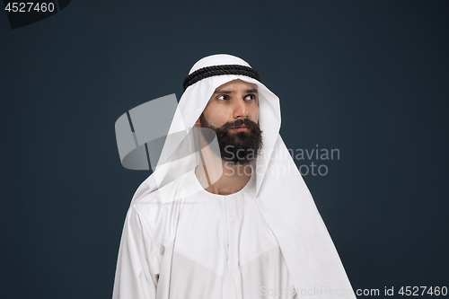 Image of Arabian saudi businessman on dark blue studio background