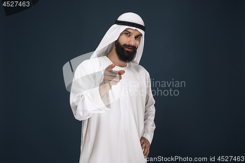 Image of Arabian saudi businessman on dark blue studio background