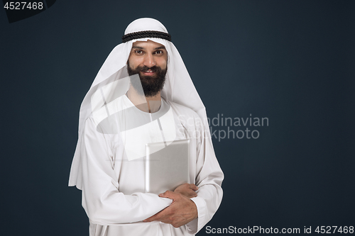 Image of Arabian saudi businessman on dark blue studio background