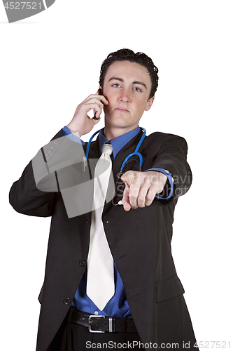 Image of Young doctor talking on a cell phone and Pointing