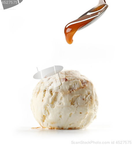 Image of caramel sauce pouring on ice cream