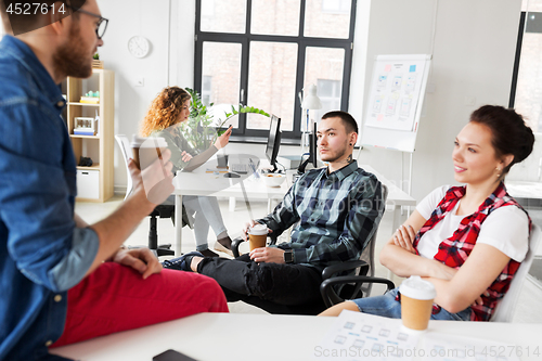 Image of creative team drinking coffee at office