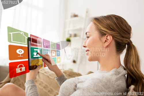 Image of woman with tablet computer and smart home icons