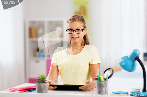 Image of student girl with tablet computer doing homework