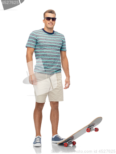 Image of smiling young man with skateboard over white