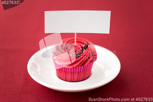 Image of close up of cupcake with red buttercream frosting