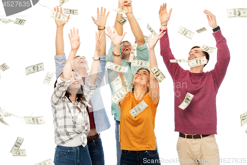 Image of happy friends picking money falling from up above