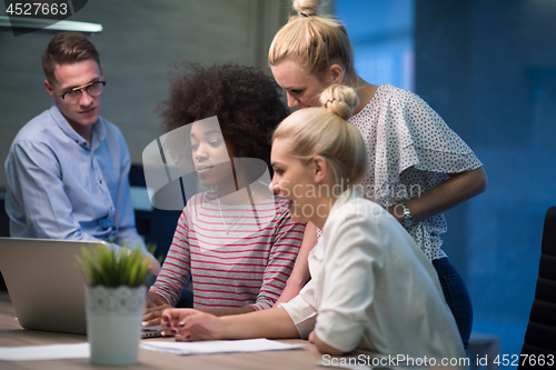 Image of Multiethnic startup business team in night office