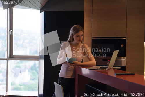 Image of woman eating breakfast enjoying relaxing lifestyle