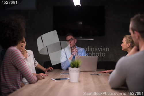 Image of Multiethnic startup business team in night office