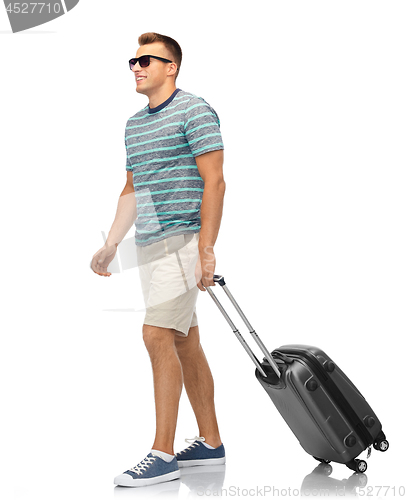 Image of man in sunglasses with travel bag