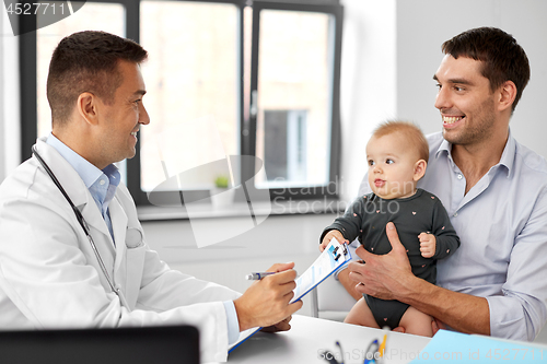 Image of father with baby and doctor at clinic