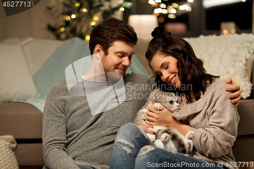 Image of happy couple with cat at home