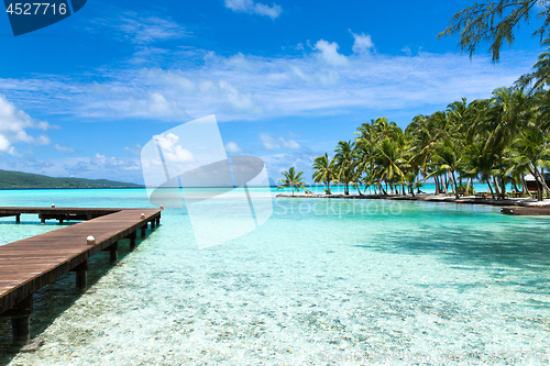 Image of wooden pier on tropical beach in french polynesia