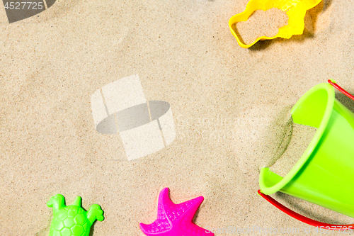 Image of close up of sand toys kit on summer beach