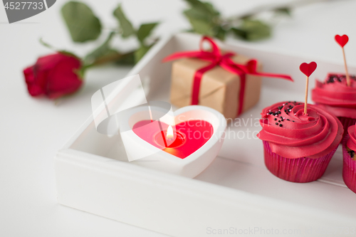 Image of close up of candle and cupcakes for valentines day