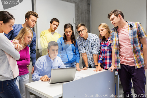 Image of students and teacher with laptop at school