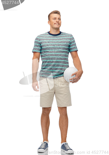 Image of smiling young man with volleyball