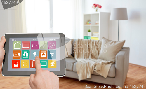 Image of hands with smart home icons on tablet computer
