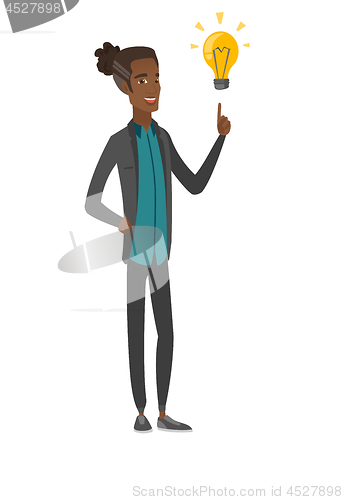 Image of African businessman pointing at idea lightbulb.
