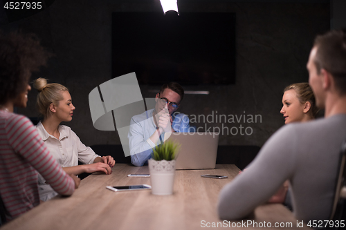 Image of Multiethnic startup business team in night office