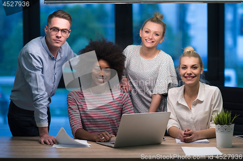 Image of Multiethnic startup business team in night office