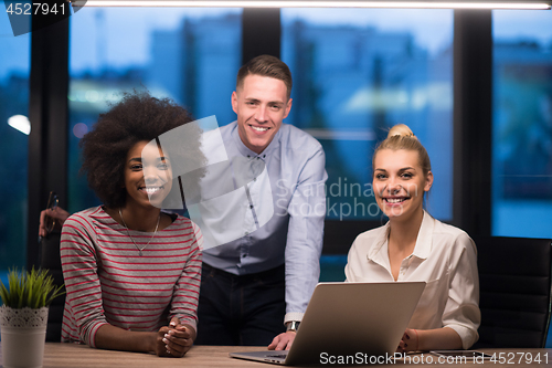 Image of Multiethnic startup business team in night office