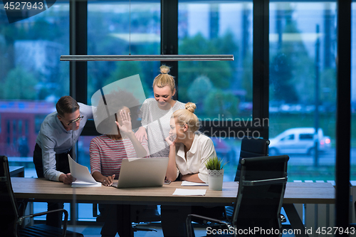 Image of Multiethnic startup business team in night office