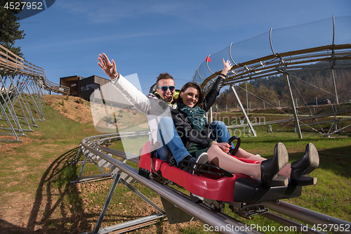 Image of couple enjoys driving on alpine coaster