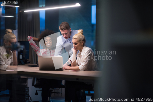 Image of Multiethnic startup business team in night office