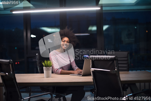 Image of black businesswoman using a laptop in startup office